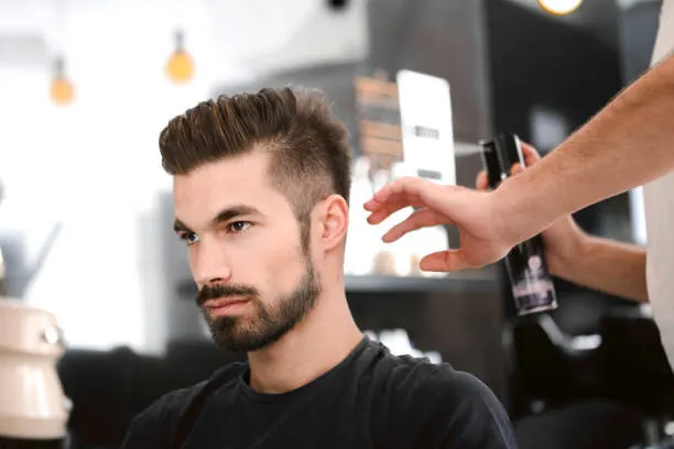 Hairdresser spraying hair with water