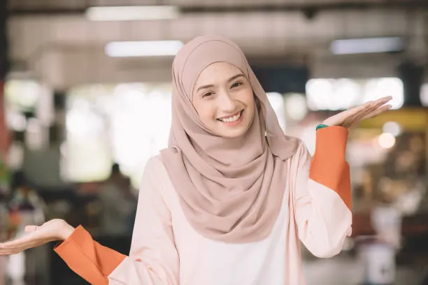 one asian muslim female headshot at wet market in the morning outdoor with positive emotion